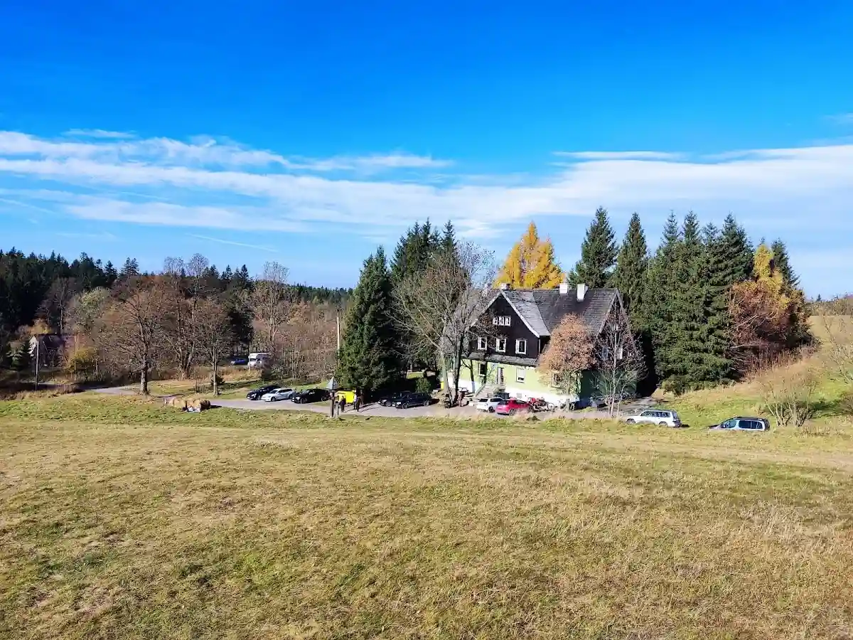 Budynek Schroniska Pasterka zimą o zmierzchu pod gwieździstym niebem.
