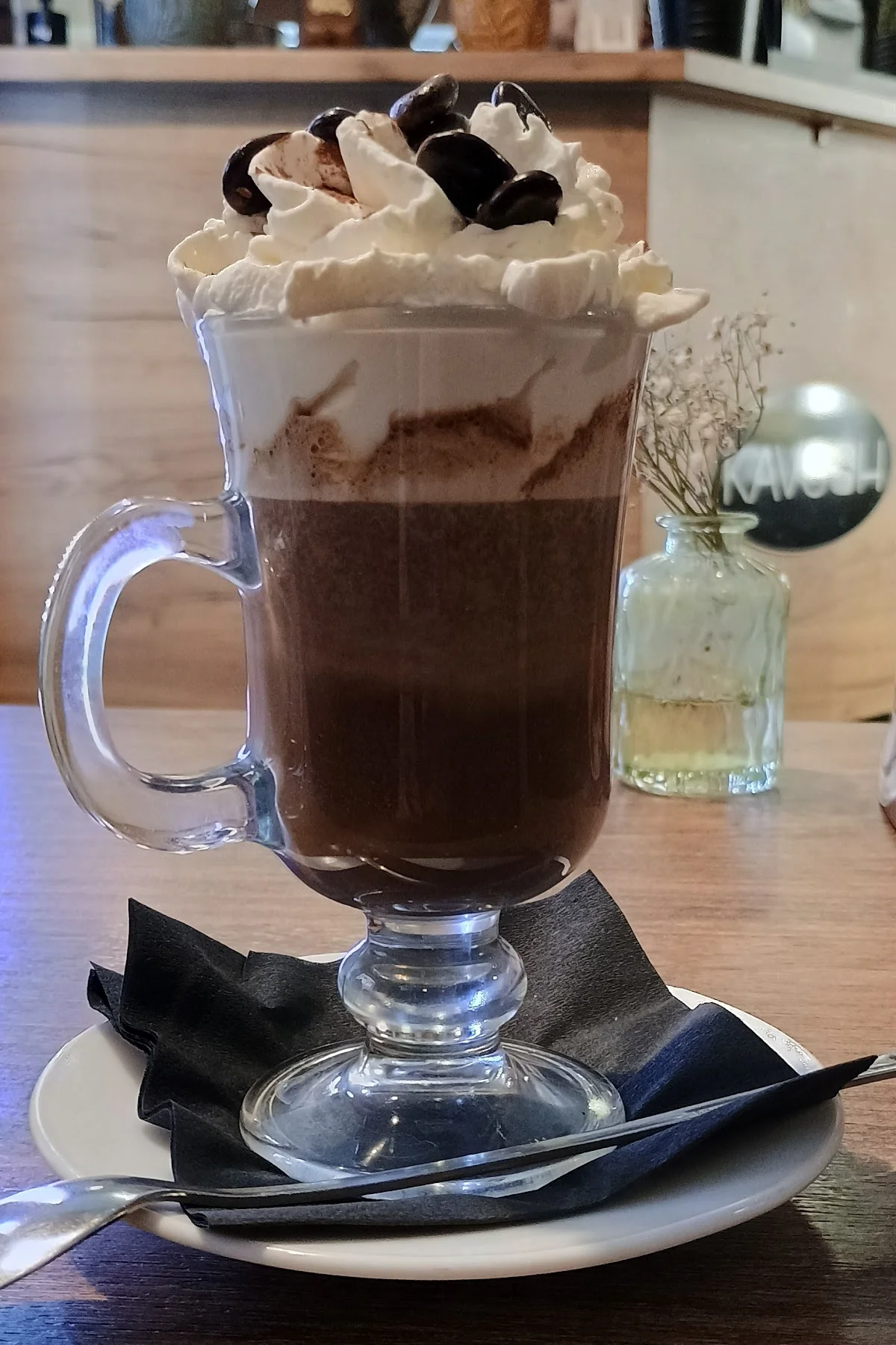 Czekolada na gorąco z bitą śmietaną w szklance.